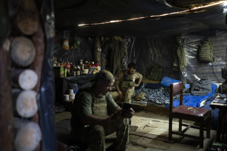 Ukrainian soldiers rest in a trench on the front line in the outskirts of Lyman, Ukraine, Tuesday, Aug. 15, 2023. Moscow’s army is staging a ferocious push in northeast Ukraine designed to distract Ukrainian forces from their counteroffensive and minimize the number of troops Kyiv is able to send to more important battles in the south. (AP Photo/Bram Janssen)