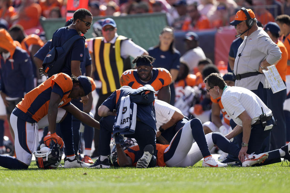 Denver Broncos wide receiver K.J. Hamler is helped after an injury against the New York Jets during the first half of an NFL football game, Sunday, Sept. 26, 2021, in Denver. (AP Photo/David Zalubowski)