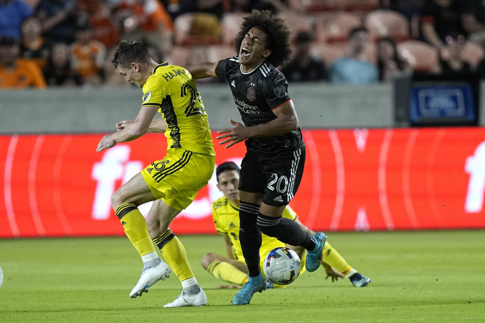 Houston Dynamo's Adalberto Carrasquilla (20) is fouled by Nashville SC's Luke Haakenson (26) during the first half of a soccer match Saturday, May 14, 2022, in Houston. (AP Photo/David J. Phillip)