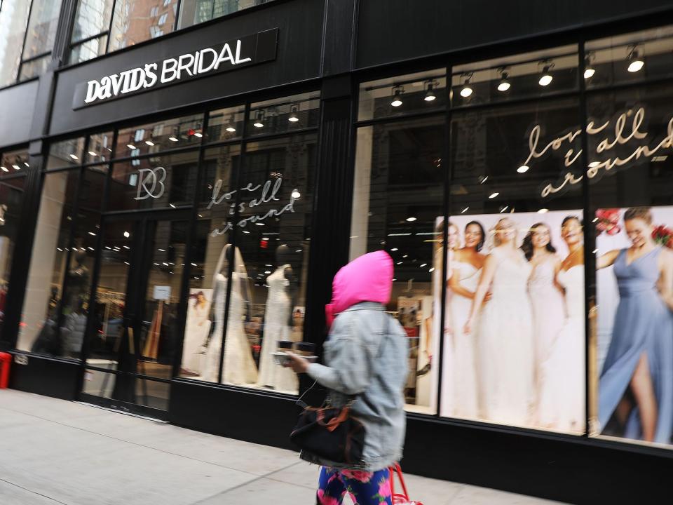 Person walks by exterior of David's Bridal store