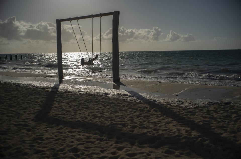 Tourist Loren Fantasia from Baltimore, swings on the beach before the arrival of Hurricane Dorian, in Freeport, Bahamas, Friday, Aug. 30, 2019. Forecasters said the hurricane is expected to keep on strengthening and become a Category 3 later in the day. (AP Photo / Ramon Espinosa)