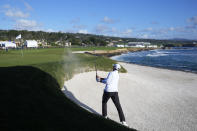 Rickie Fowler hits from a bunker toward the 18th green at Pebble Beach Golf Links during the second round of the AT&T Pebble Beach National Pro-Am golf tournament in Pebble Beach, Calif., Friday, Feb. 2, 2024. (AP Photo/Eric Risberg)