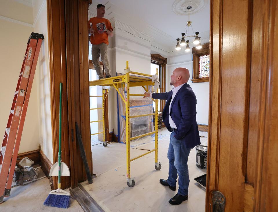 Dave Durocher, executive director of The Other Side Academy, talks with Christopher Lynch during renovation of the Armstrong Mansion in Salt Lake City on Wednesday, March 29, 2023. The organization works with former prisoners hoping to rehabilitate their lives. | Jeffrey D. Allred, Deseret News