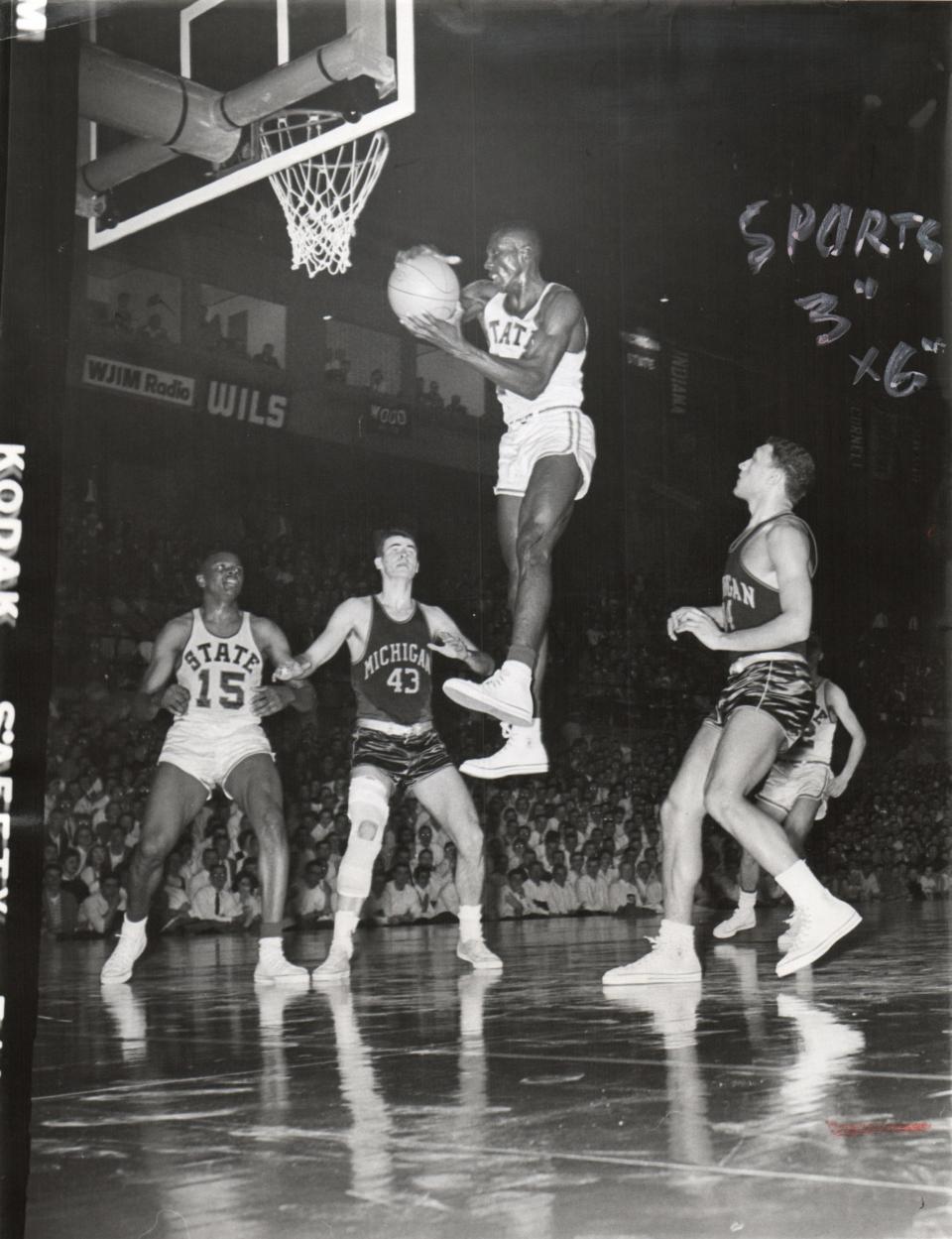 Former Michigan State basketball star Johnny Green pulls down a rebound against Michigan on Feb. 16, 1959.