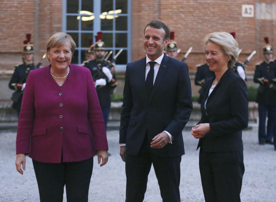 German Chancellor Angela Merkel, left, and French President Emmanuel Macron, center, welcome European Commission President Ursula von der Leyen for a dinner in Toulouse, southwestern France, Wednesday, Oct.16, 2019. President Emmanuel Macron and Chancellor Angela Merkel sought Wednesday to demonstrate the solidity of the French-German relationship at a meeting in southern France, one day before a key EU summit that may approve a divorce deal with Britain.(AP Photo/Frederic Scheiber)