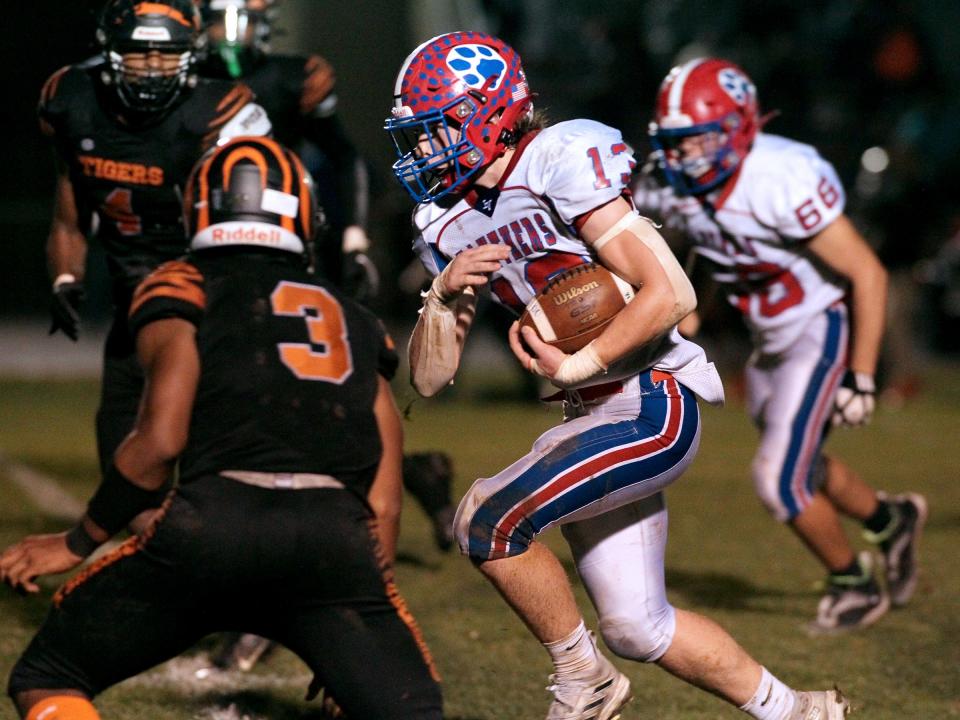 Licking Valley's Logan Workman runs through the East defense during the visiting Panthers' 40-6 victory Friday.