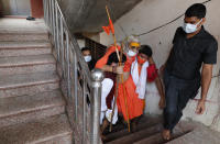 Hindu devotees carry their guru Shankaracharya Swami Vasudevanand Saraswati Guru up the stairs on the occasion of Guru Purnima, or full moon day dedicated to the Guru, in Prayagraj, India. Saturday, July 24, 2021. The festival is observed to worship and express gratitude to teachers. (AP Photo/Rajesh Kumar Singh)