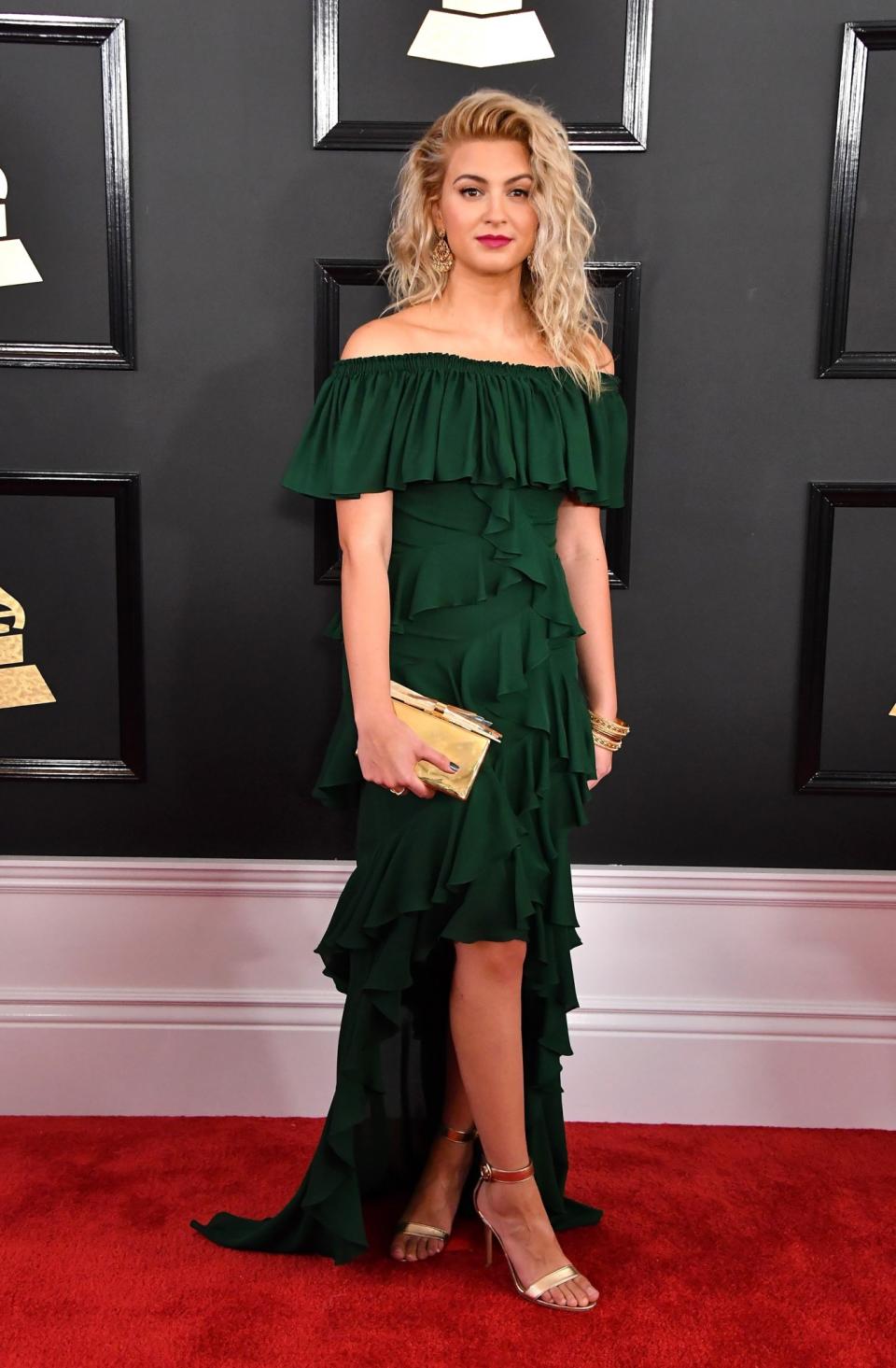 <p>Tori Kelly strutted the red carpet in a ruffled, floor-sweeping forest green off-the-shoulder number. She accessorized with a golden clutch and tousled blonde locks! </p>