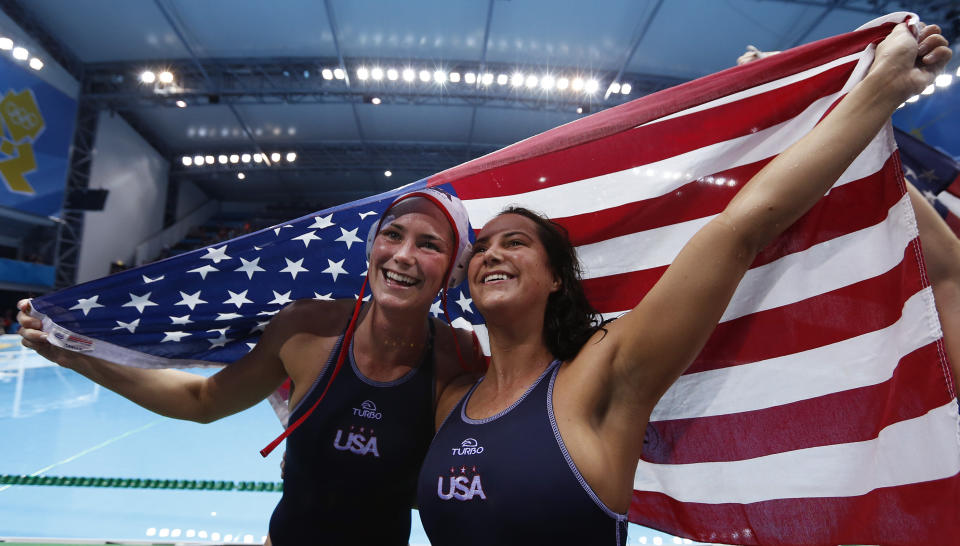 FILE - Jessica Steffens, left with her sister Maggie Steffens of the United States pose for the cameras after winning their women's water polo gold medal match against Spain at the 2012 Summer Olympics, Thursday, Aug. 9, 2012, in London. Maggie has gone on to become one of the greatest water polo players in history.(AP Photo/Alastair Grant, File)