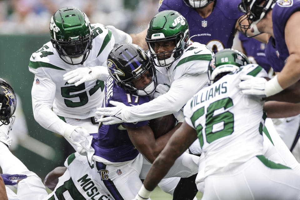 Baltimore Ravens' Kenyan Drake (17) is tackled by New York Jets' C.J. Mosley (57) and Elijah Moore during the first half of an NFL football game Sunday, Sept. 11, 2022, in East Rutherford, N.J. (AP Photo/Adam Hunger)