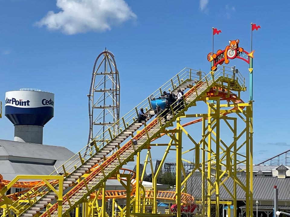 Riders on Cedar Point's new Wild Mouse roller coaster are evacuated Thursday after the ride abruptly stopped during a preview for roller coaster enthusiasts and the media.