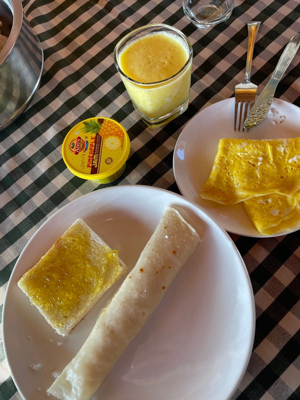 Eggs and rolled breakfast on gingham tablecloth