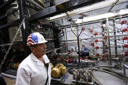 A U.S. merchant marine officer is seen in the FDHS Field Deployable Hidrolysis System of the U.S. MV Cape Ray ship docked at the naval airbase in Rota, near Cadiz, southern Spain April 10, 2014. REUTERS/Marcelo del Pozo