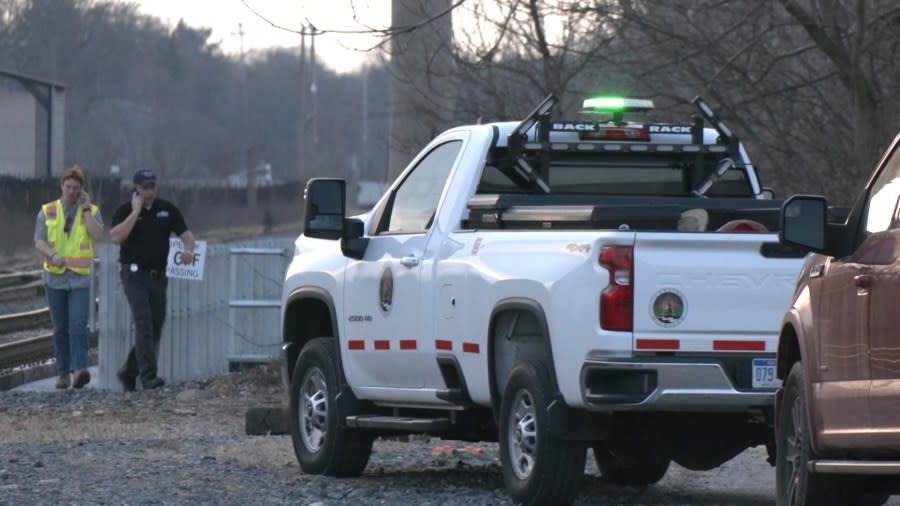 City officials and state environmental regulators check a railroad bridge in REO Town in Lansing. It is allegedly the source of contamination in the Grand River. (WLNS)