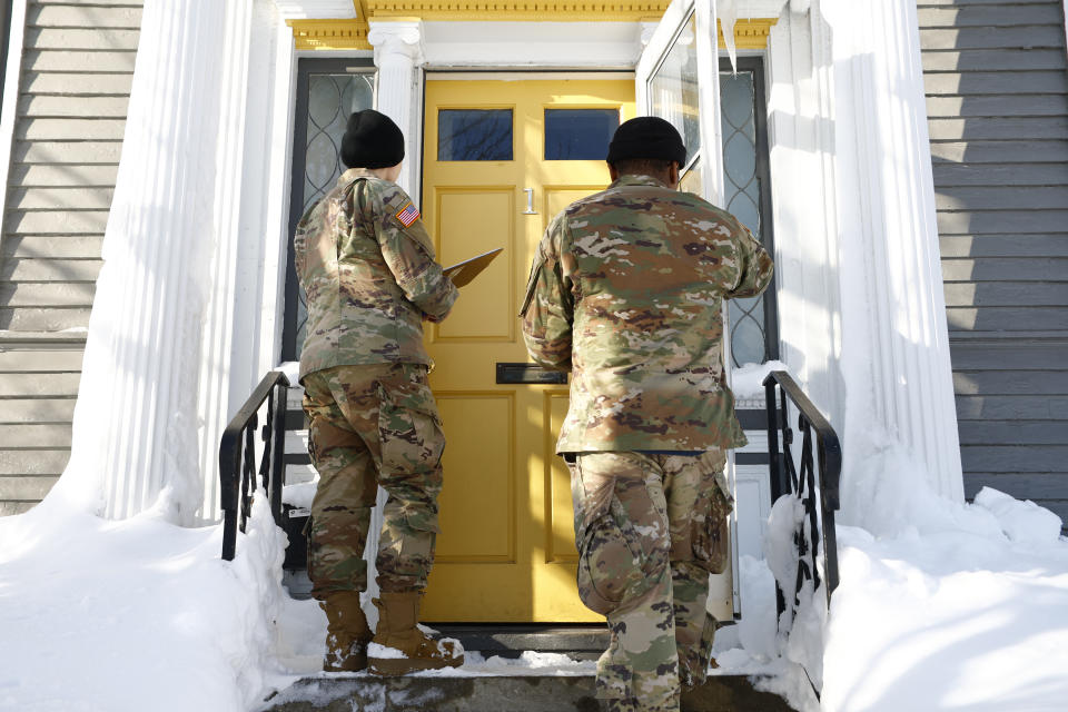 National guard members check on residents, Wednesday, Dec. 28, 2022, in Buffalo N.Y., following a winter storm. The National Guard went door to door in parts of Buffalo on Wednesday to check on people who lost power during the area’s deadliest winter storm in decades, and authorities faced the tragic possibility of finding more victims amid melting snow. (AP Photo/Jeffrey T. Barnes)