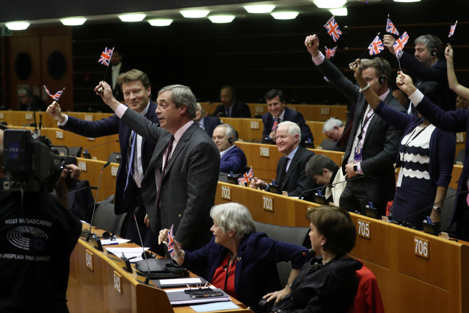 Brexit Party leader Nigel Farage along with other MEPs wave British flags ahead of a vote on the Withdrawal Agreement at the European Parliament in Brussels, Belgium January 29, 2020. REUTERS/Yves Herman