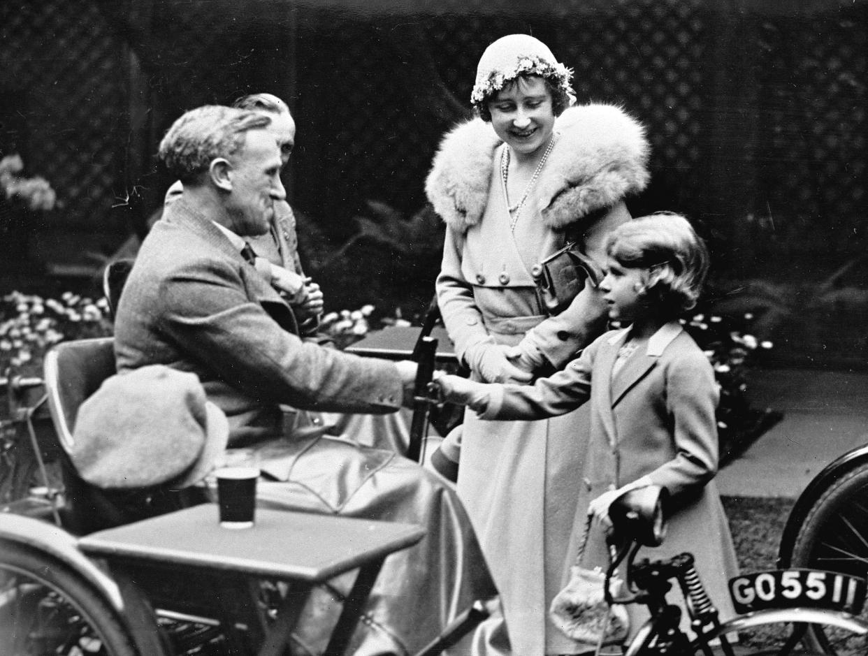 Britain's Princess Elizabeth, later to become Queen Elizabeth II, is introduced by her mother, the Duchess of York, to disabled soldiers at an exhibition of their work in London, May 16, 1933. 