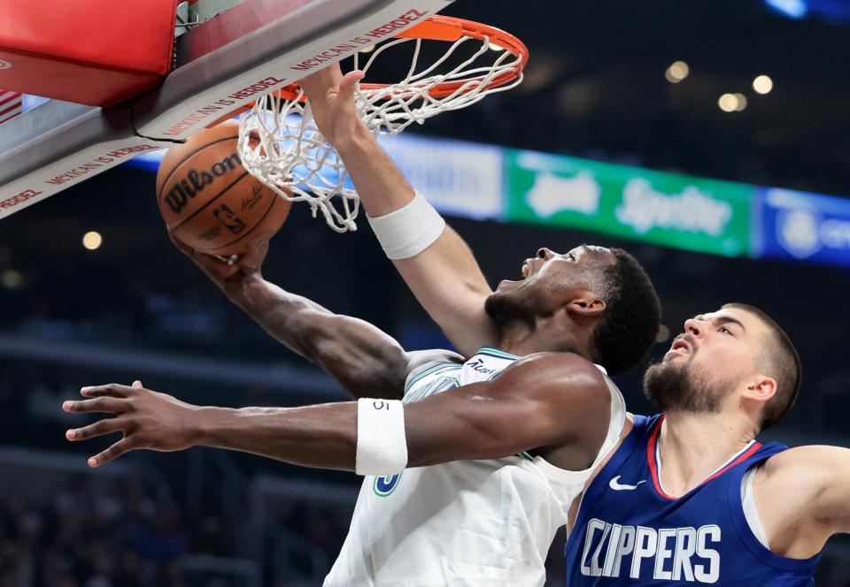 Anthony Edwards scores while being fouled by Ivica Zubac.