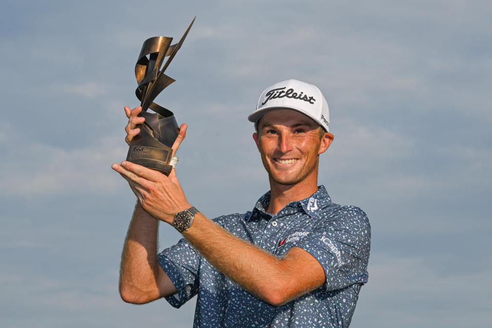 Seen here, Will Zalatoris holds the FedEx St. Jude Championship trophy aloft.