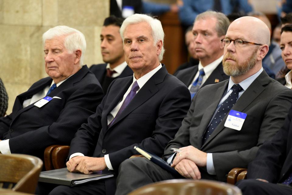 George Norcross, center, waits to testify for the first time before the New Jersey Senate select committee on Economic Growth Strategies in Trenton on November 18, 2019.