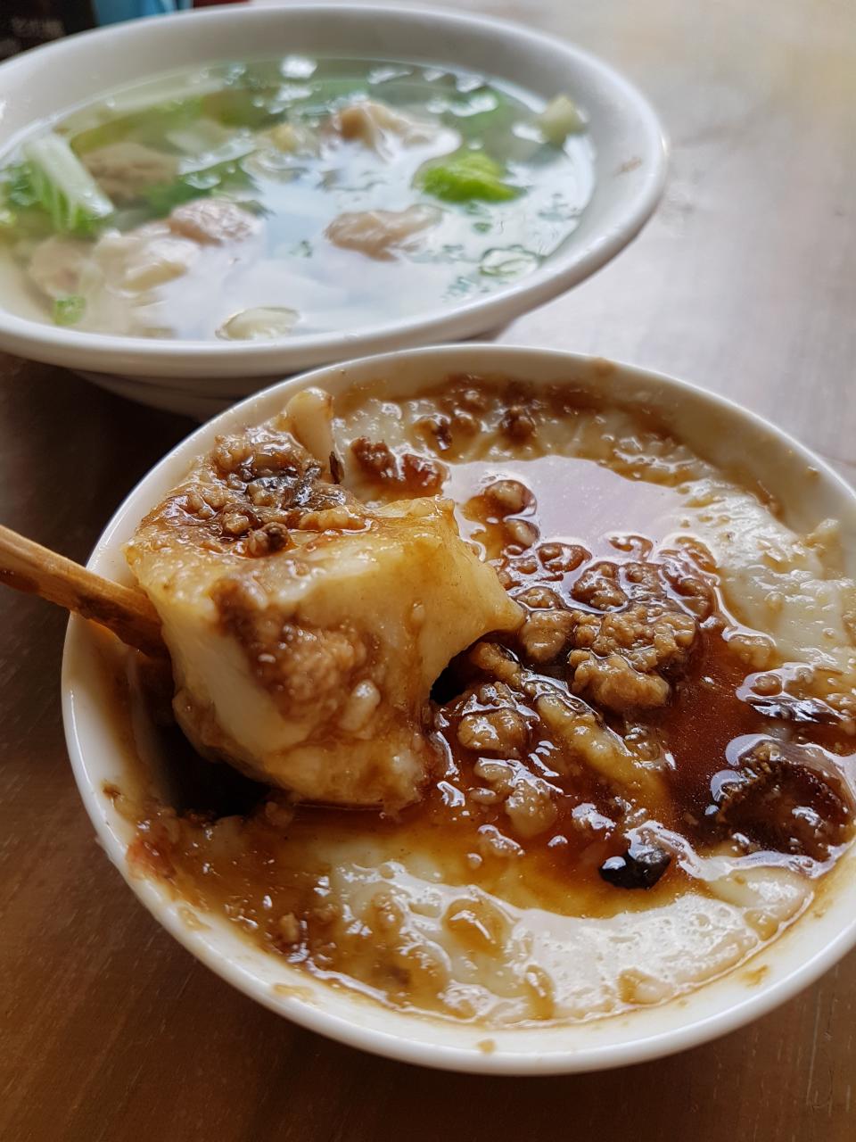 ▲用木片吃的碗粿(25元)，醬汁甘甜、肉燥噴香，也是老街碗粿的招牌菜。