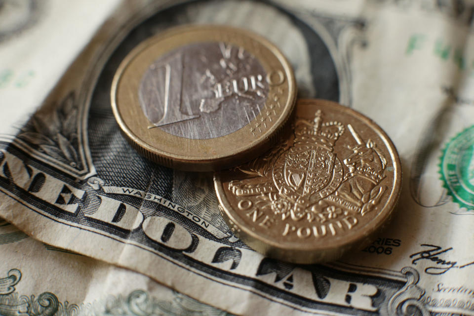 A British one pound coin, a euro coin and a US one dollar bill, in London.