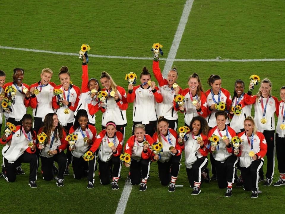 Canada's women's soccer team pose with their gold medals during the victory ceremony at the Tokyo Olympic Games in 2021. (Tiziana Fabi/Getty Images - image credit)