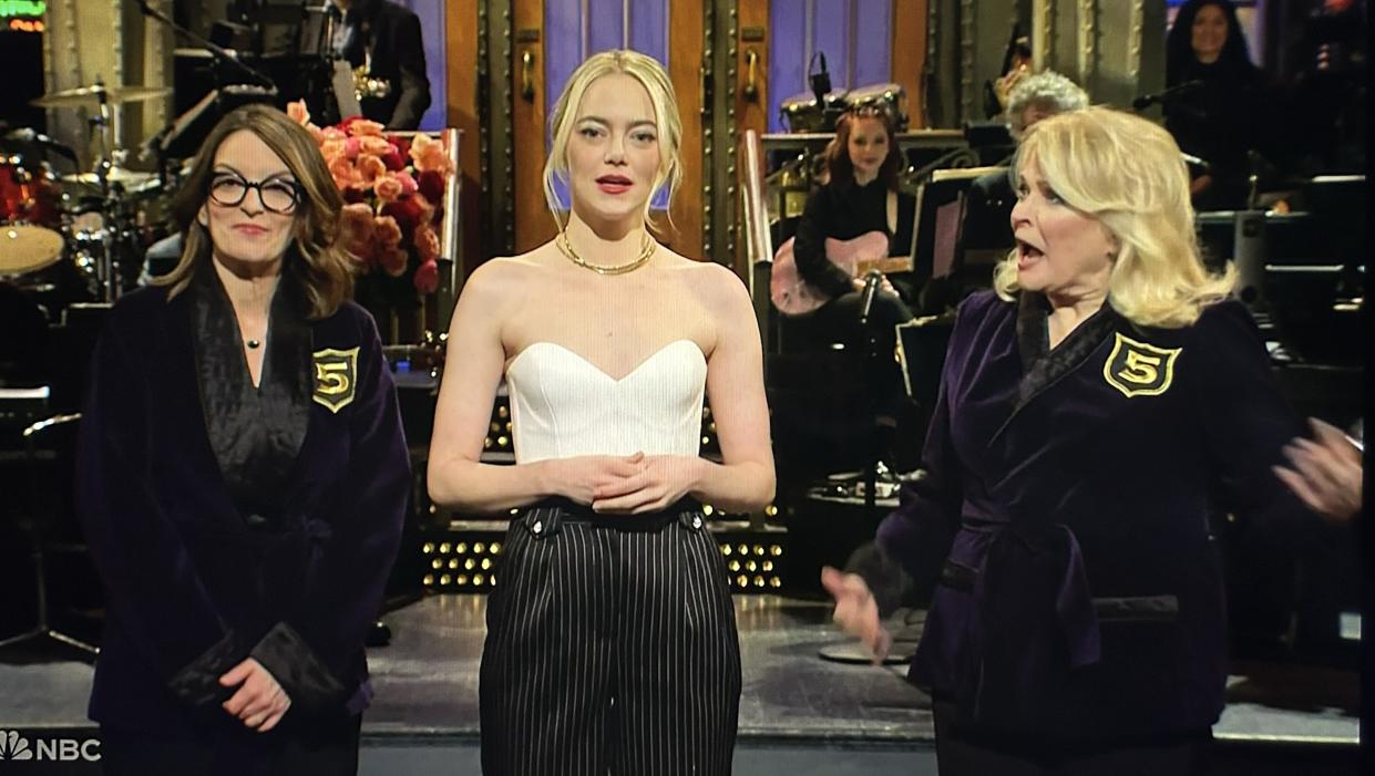 SNL host Emma Stone is flanked by Tina Fey and Candice Bergen.