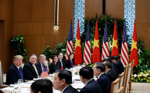 Donald Trump speaks during a meeting with Vietnamese Prime Minister Nguyen Xuan Phuc as aides to both leaders look on - Credit: AP Photo/ Evan Vucci