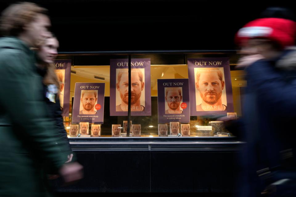 Pedestrians pass a display in the window of a book shop in London, Tuesday, Jan. 10, 2023.