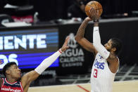 Los Angeles Clippers guard Paul George, right, shoots as Washington Wizards forward Rui Hachimura defends during the first half of an NBA basketball game Tuesday, Feb. 23, 2021, in Los Angeles. (AP Photo/Mark J. Terrill)