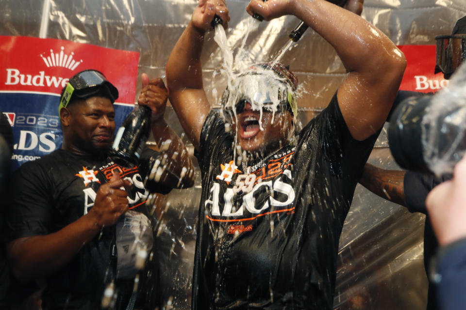 The Houston Astros celebrate in the locker room after the team defeated the Minnesota Twins in Game 4 to win a baseball AL Division Series, Wednesday, Oct. 11, 2023, in Minneapolis. (AP Photo/Stacy Bengs)