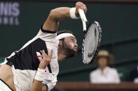 Nikoloz Basilashvili, of Georgia, serves against Cameron Norrie, of Britain, in the singles final at the BNP Paribas Open tennis tournament, Sunday, Oct. 17, 2021, in Indian Wells, Calif. (AP Photo/Mark J. Terrill)