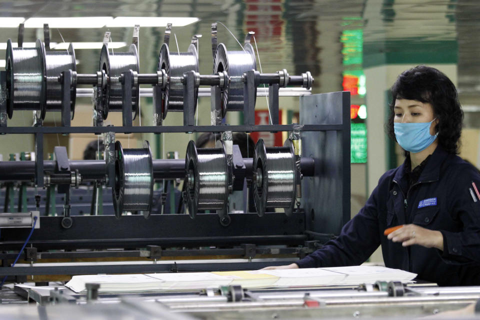 An employee at the Mindulle Notebook Factory assembles notebooks in a larger quantity to pupils and students across the country in Pyongyang, North Korea, Thursday, Nov. 12, 2020. North Korea is staging an “80-day battle,” a propaganda-heavy productivity campaign meant to bolster its internal unity and report greater production in various industry sectors ahead of a ruling party congress in January. (AP Photo/Jon Chol Jin)