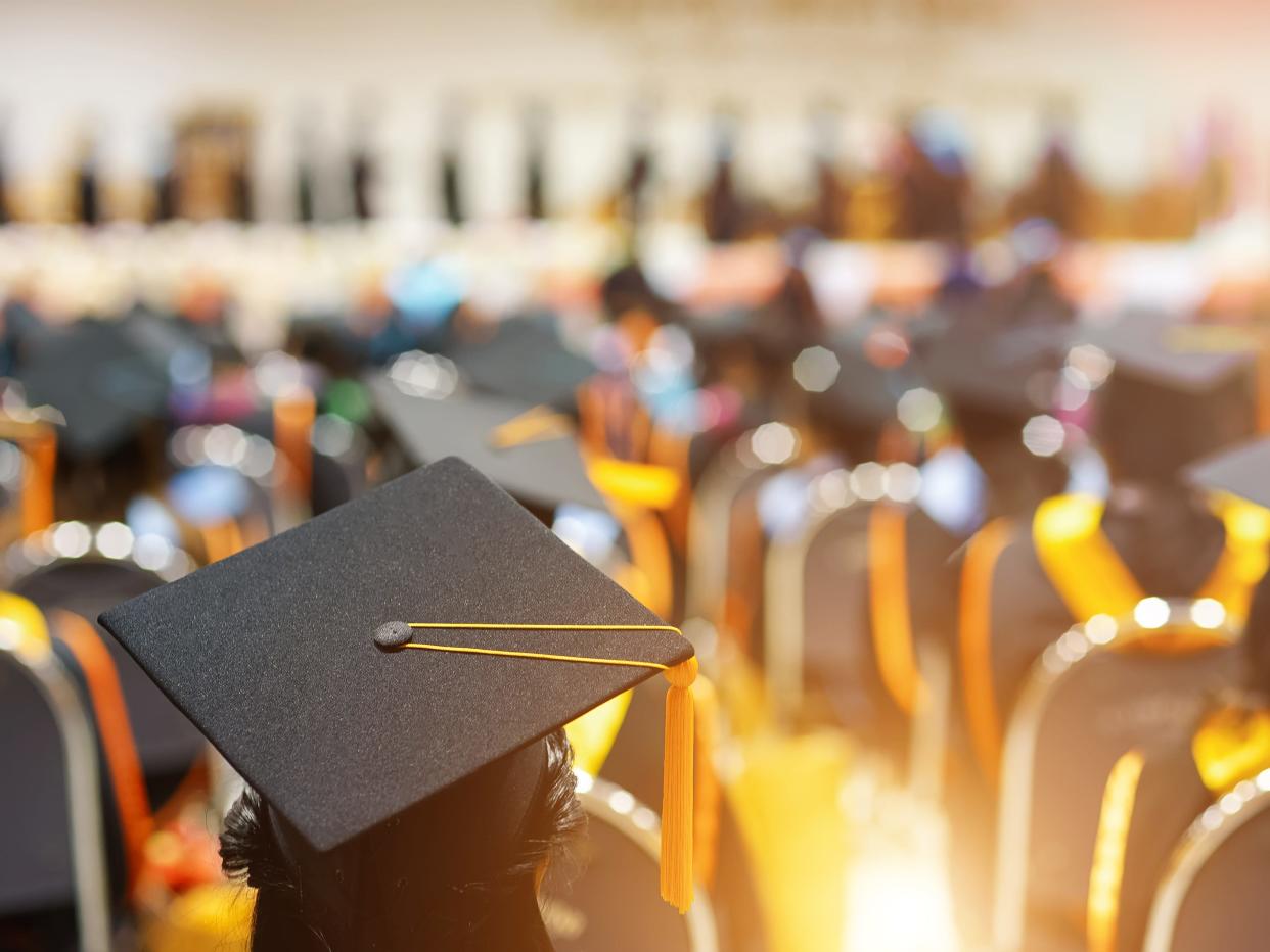 Rear view of college graduates