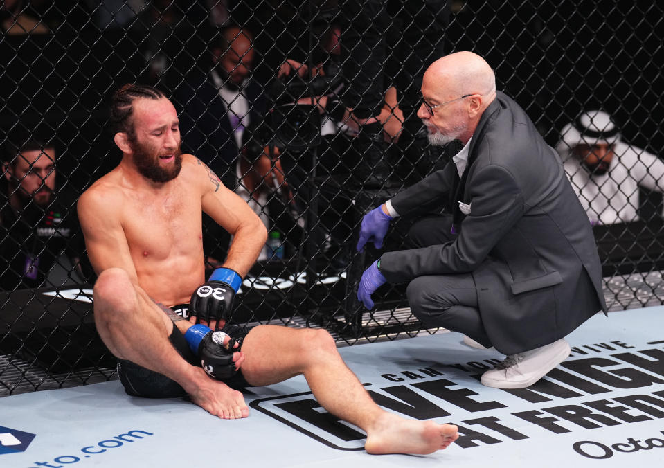 ABU DHABI, UNITED ARAB EMIRATES - OCTOBER 21: Victor Henry reacts after receiving a low blow from opponent Javid Basharat of Afghanistan in a bantamweight fight during the UFC 294 event at Etihad Arena on October 21, 2023 in Abu Dhabi, United Arab Emirates. (Photo by Chris Unger/Zuffa LLC via Getty Images)