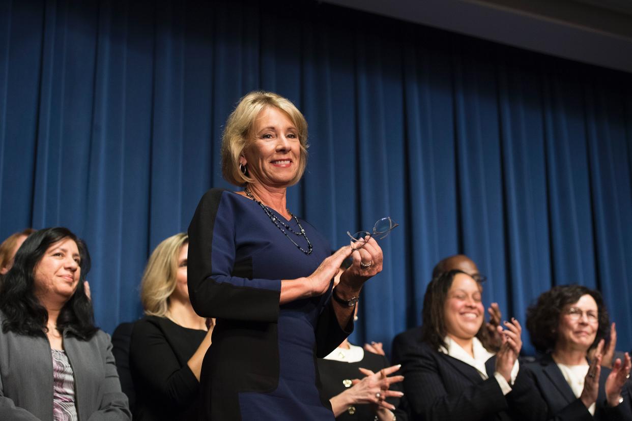Education Secretary Betsy DeVos (C) stands with her transition team as she delivers remarks to staff on &quot;the importance of the work and mission&quot; of the Education Department on her first day as secretary in Washington, DC, February 8, 2017. / AFP / JIM WATSON        (Photo credit should read JIM WATSON/AFP via Getty Images)