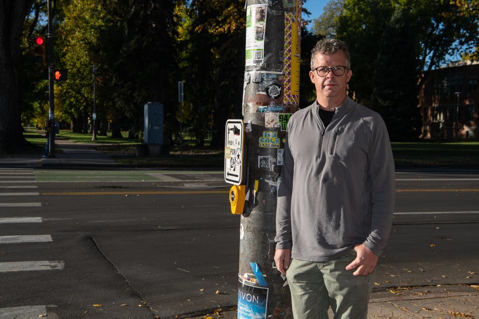 Harris Elias, a Fort Collins resident who was wrongfully arrested for a DUI, poses for a portrait near the site of his arrest at the corner of Laurel Street and College Avenue Wednesday, Oct. 18, 2023, in Fort Collins, Colo. His case was later dismissed after blood test results showed no alcohol or drugs detected.