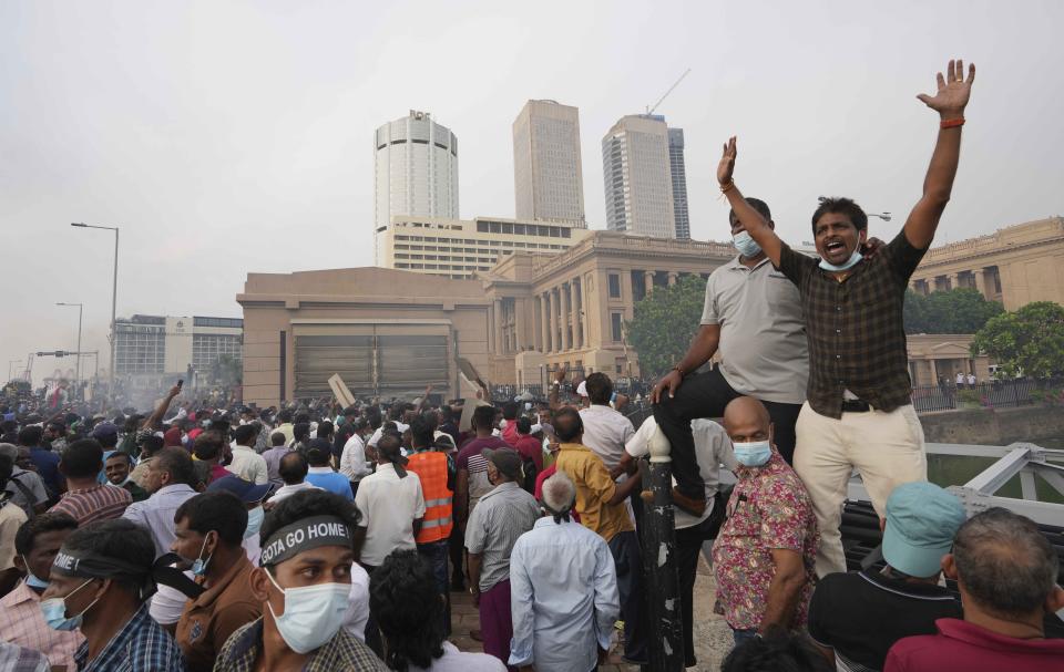 Supporters of Sri Lanka's main opposition shout slogans during a protest outside the president's office in Colombo, Sri Lanka, Tuesday, March 15, 2022. The protestors were demanding the resignation of President Gotabaya Rajapaksa as the country suffers one of the worst economic crises in history. (AP Photo/Eranga Jayawardena)