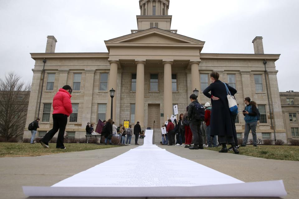 Members of COGS UE Local 896, representing University of Iowa graduate student workers, unravel a petition against graduate student fees on the steps of the Pentacrest Tuesday, March 5, 2024 on the University of Iowa campus in Iowa City, Iowa.