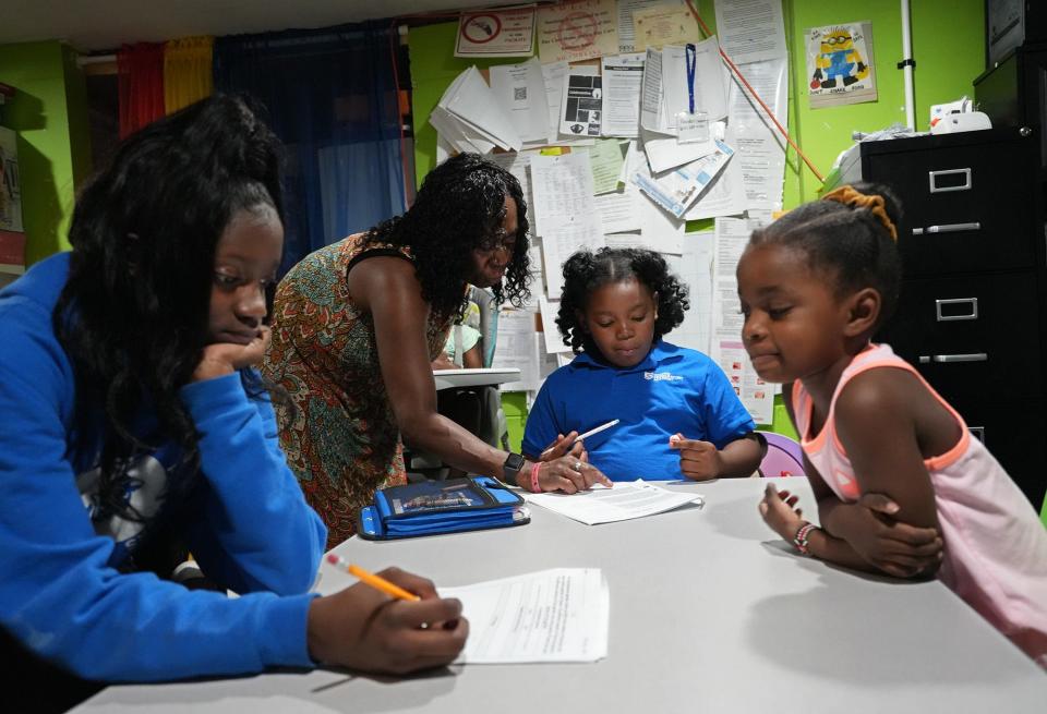 To help address childcare issues in Greater Columbus, organization Action For Children partnered with the city of Columbus and Franklin County on a new program called Rise. The initiative offers scholarships for parents, as well as signing bonuses for childcare workers. Rhonda West, who operates a home childcare center, Rhonda's Daycare Service, helps Fallon Conyers, center, with her homework. Zakayla Freeman, left, works on her homework as Skylar Moore, right, watches.