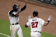 Atlanta Braves' Austin Riley (27) celebrates with teammate Freddie Freeman without contact after hitting a three-run home run in the fifth inning of a baseball game against the Toronto Blue JaysTuesday, Aug. 4, 2020, in Atlanta. (AP Photo/John Bazemore)