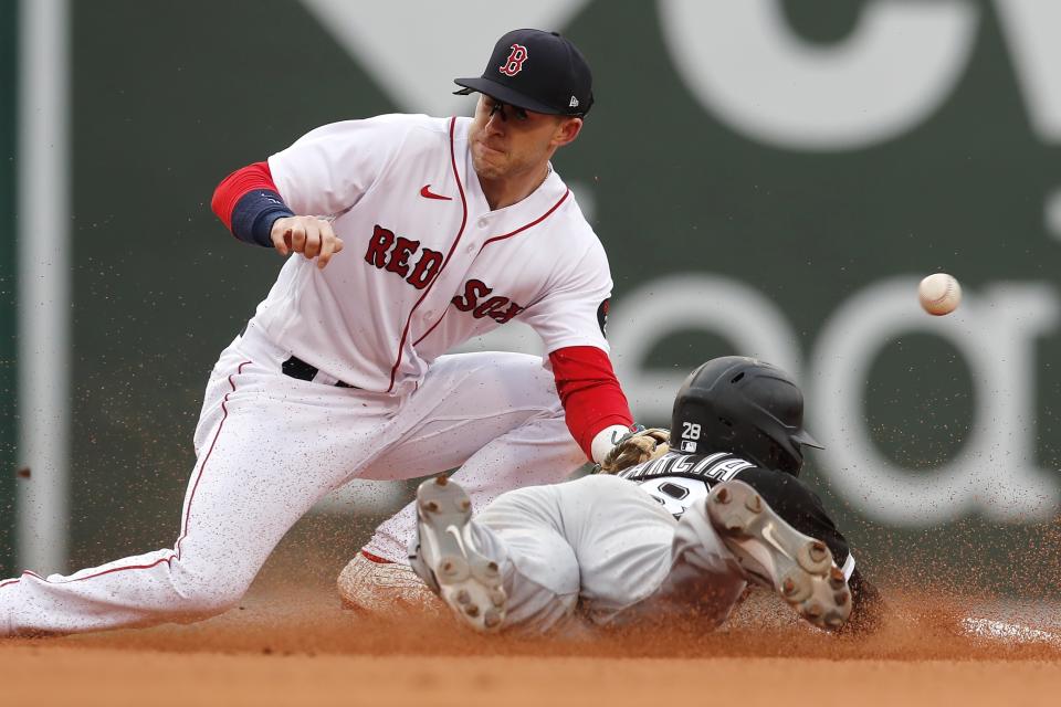 Chicago White Sox's Leury Garcia, right, steals second base as Boston Red Sox's Trevor Story misses the throw during the seventh inning of a baseball game, Saturday, May 7, 2022, in Boston. (AP Photo/Michael Dwyer)