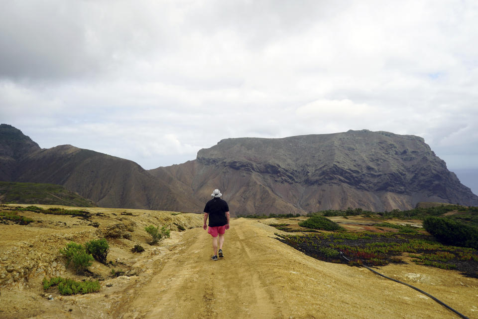 A hiker walks the Cox's Battery trail on the island of St. Helena, Wednesday, Feb. 24, 2024. The nearly three-mile trek is one of the remote territory’s 21 scenic hiking trails of varying difficulty. (AP Photo/Nicole Evatt)