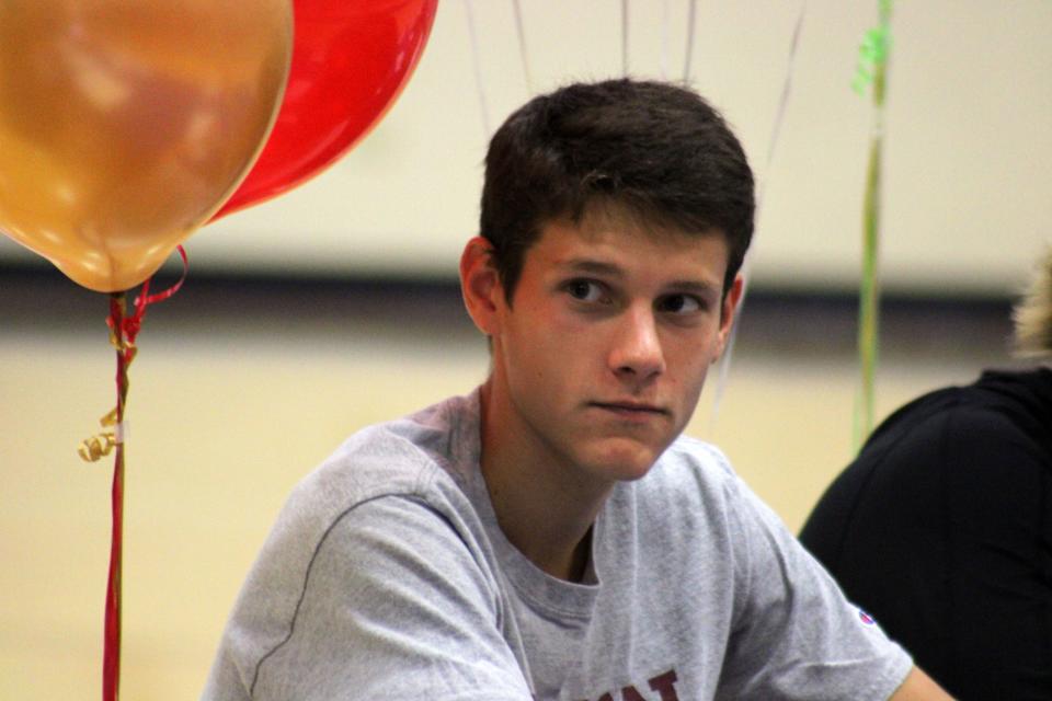 Bolles senior runner Chris Joost, who signed with Boston College, listens to announcements during Fall Signing Day ceremonies.