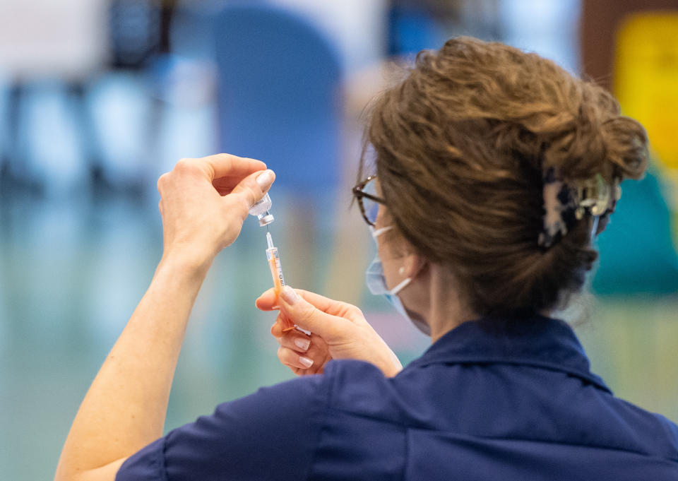 A nurse prepares a dose of the Oxford/AstraZeneca Covid-19 vaccine at the NHS vaccine centre that has been set up in the grounds of the horse racing course at Epsom in Surrey. The centre is one of the seven mass vaccination centres now opened to the general public as the UK government continues to ramp up the vaccination programme against Covid-19.