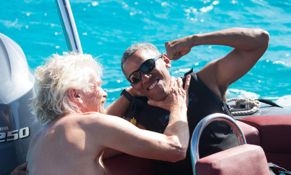 Former U.S. President Barack Obama and Richard Branson sit on a boat during Obama's holiday on Branson's Moskito island on Feb. 7, 2017.&nbsp;