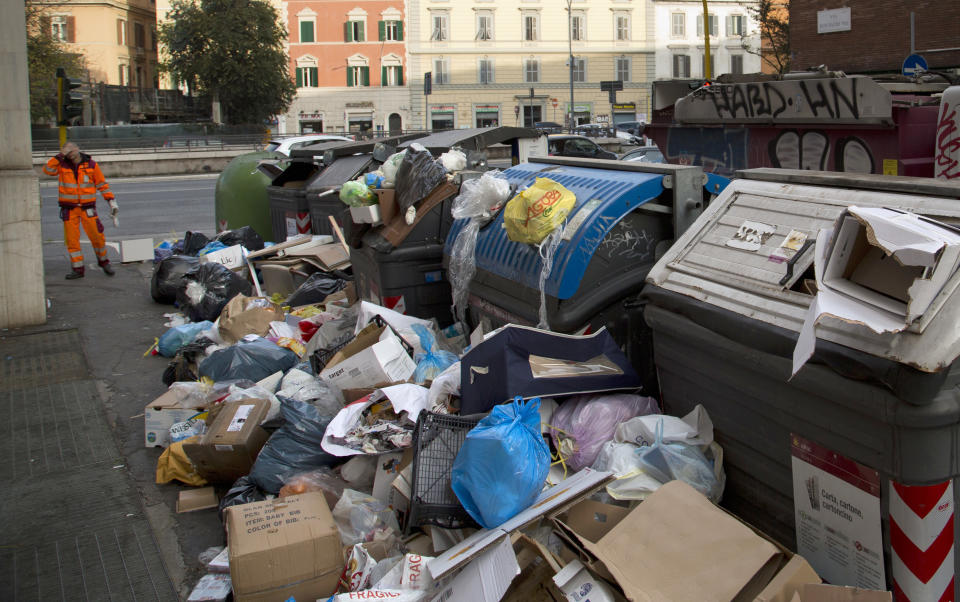 A trash collector puts his hand to his head as he looks at the accumulated garbage, in Rome, Friday, Nov. 16, 2018. Rome’s monumental problems of garbage and decay exist side-by-side with Eternal City’s glories.(AP Photo/Alessandra Tarantino)