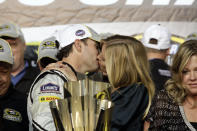 FILE - In this Nov. 16, 2008, file photo, NASCAR driver Jimmie Johnson and his wife, Chandra, celebrate after he won his third NASCAR Sprint Cup Series championship, in Homestead, Fla. Jimmie Johnson is the latest NASCAR superstar to climb out of his car, with the seven-time champion announcing Wednesday, Nov. 20, 2019, that 2020 will be his final season of full-time racing. (AP Photo/Terry Renna, File)