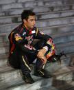 Toro Rosso Formula One driver Daniel Ricciardo of Australia sits down on steps after crashing during the Singapore F1 Grand Prix at the Marina Bay street circuit in Singapore September 22, 2013. REUTERS/Natashia Lee (SINGAPORE - Tags: SPORT MOTORSPORT F1)